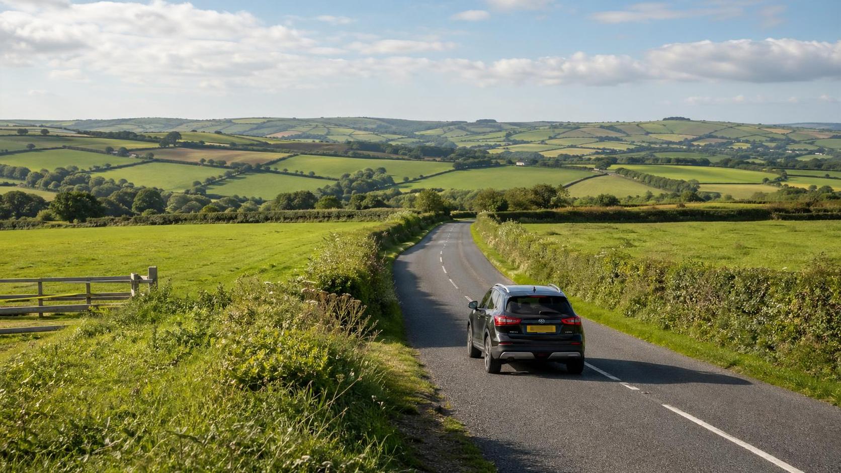 Quiet rural road near Callington running through green farmland in summer light