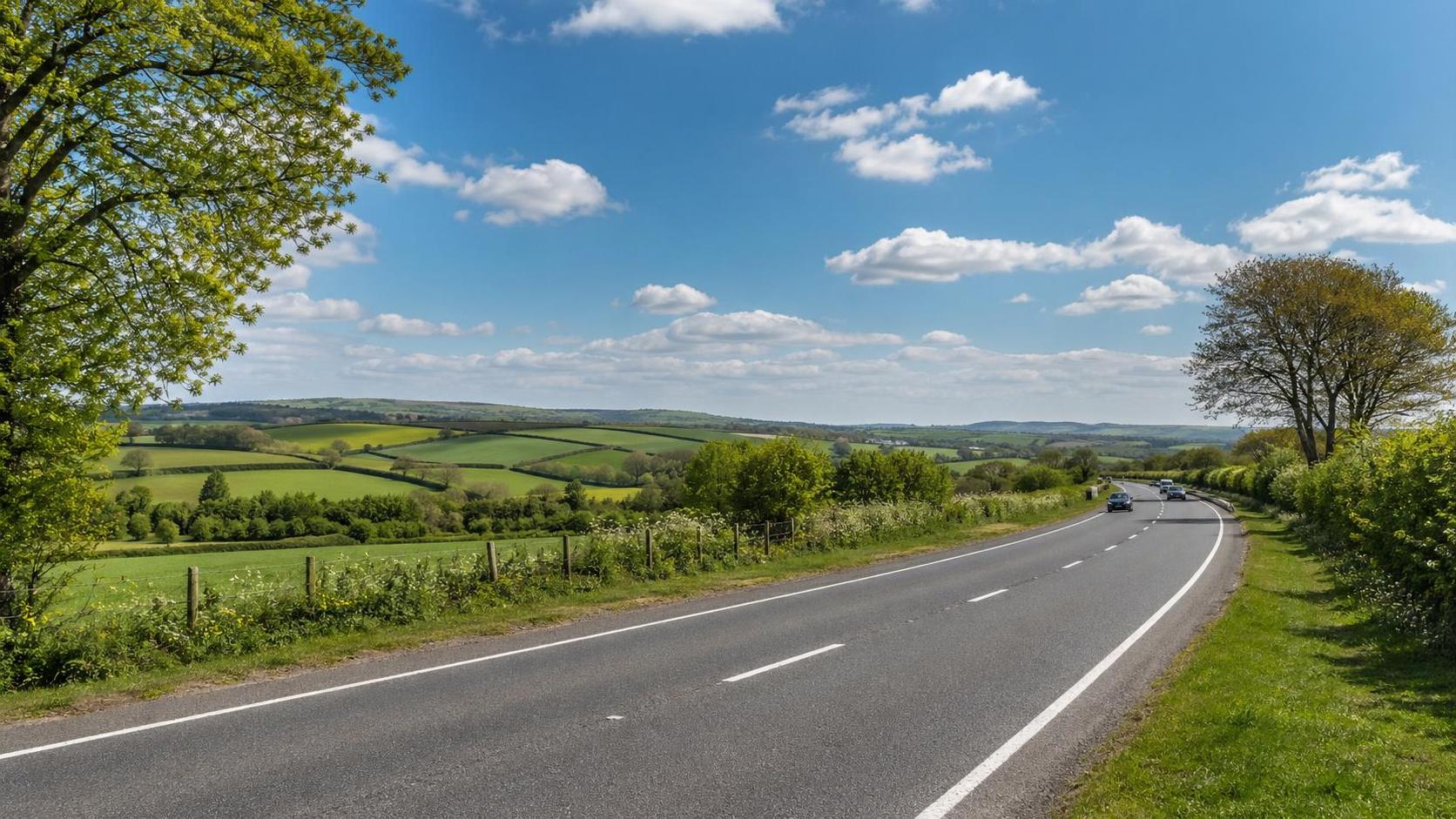 Open road near Bodmin crossing rolling farmland under a bright spring sky