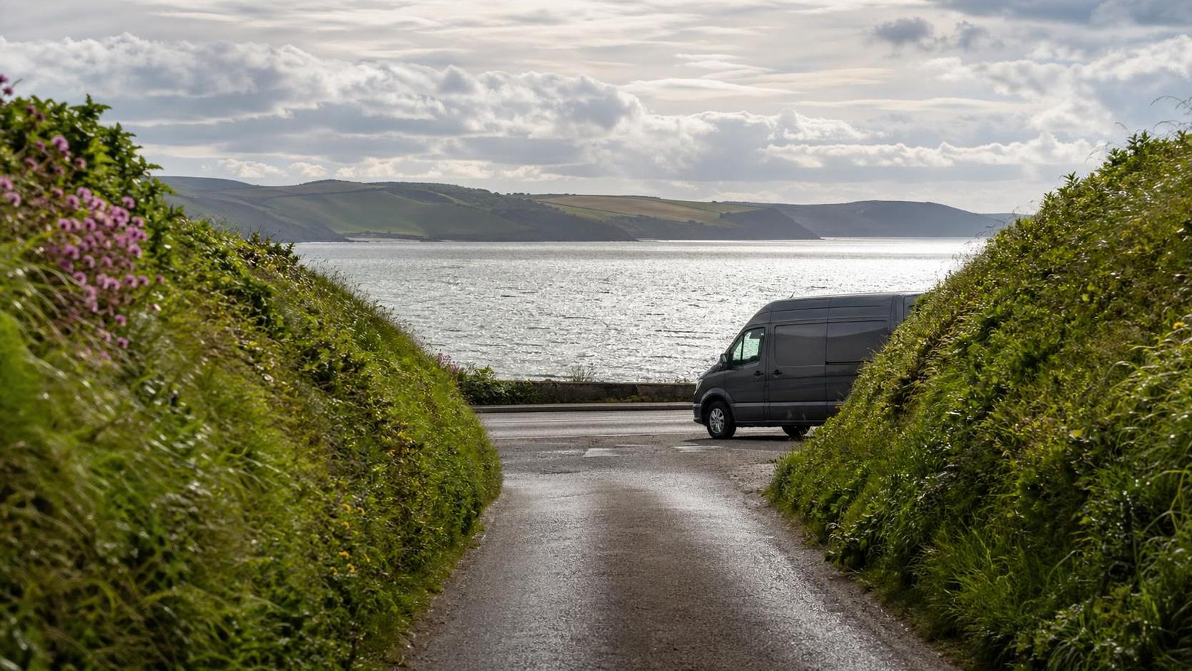 Tidy Cornish lane near Torpoint opening toward the coast in gentle mixed light